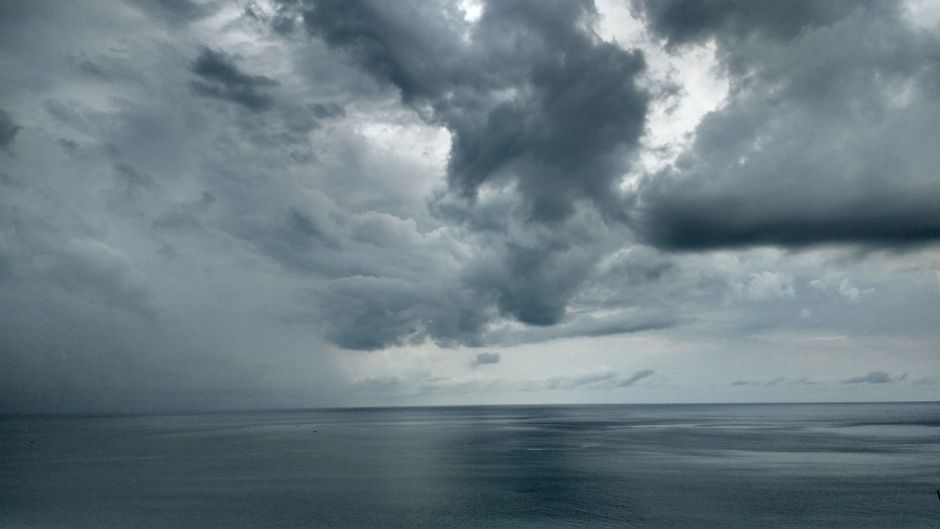 A dramatic view of storm clouds over the sea in North Sumatra, Indonesia.