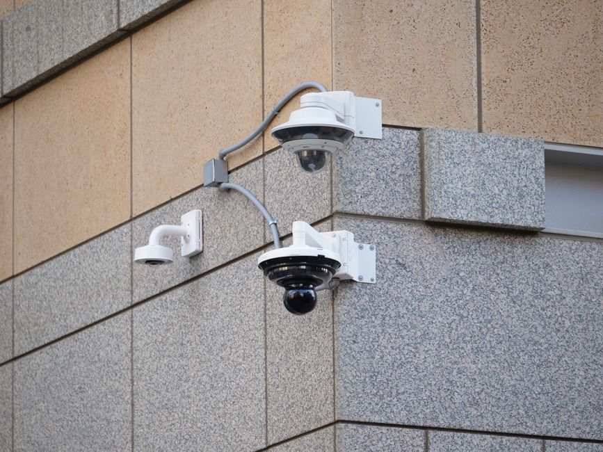 Security cameras mounted on a building wall providing surveillance and safety.