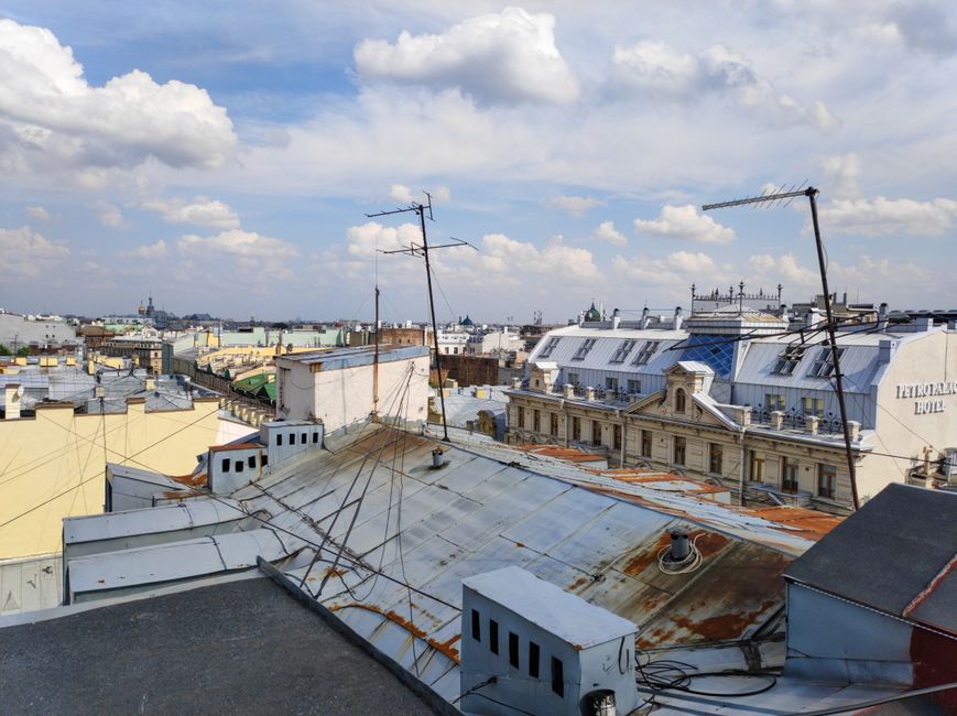 Aerial view of historic rooftops and skyline in Saint Petersburg, showcasing urban architecture and vibrant city landscape.